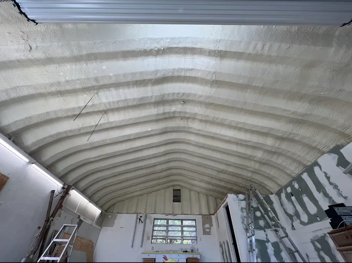 Spray polyurethane foam applied to the underside of a metal roof deck in DeForest